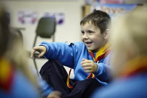 A Beaver Scout smiling during an activity at a Beaver meeting