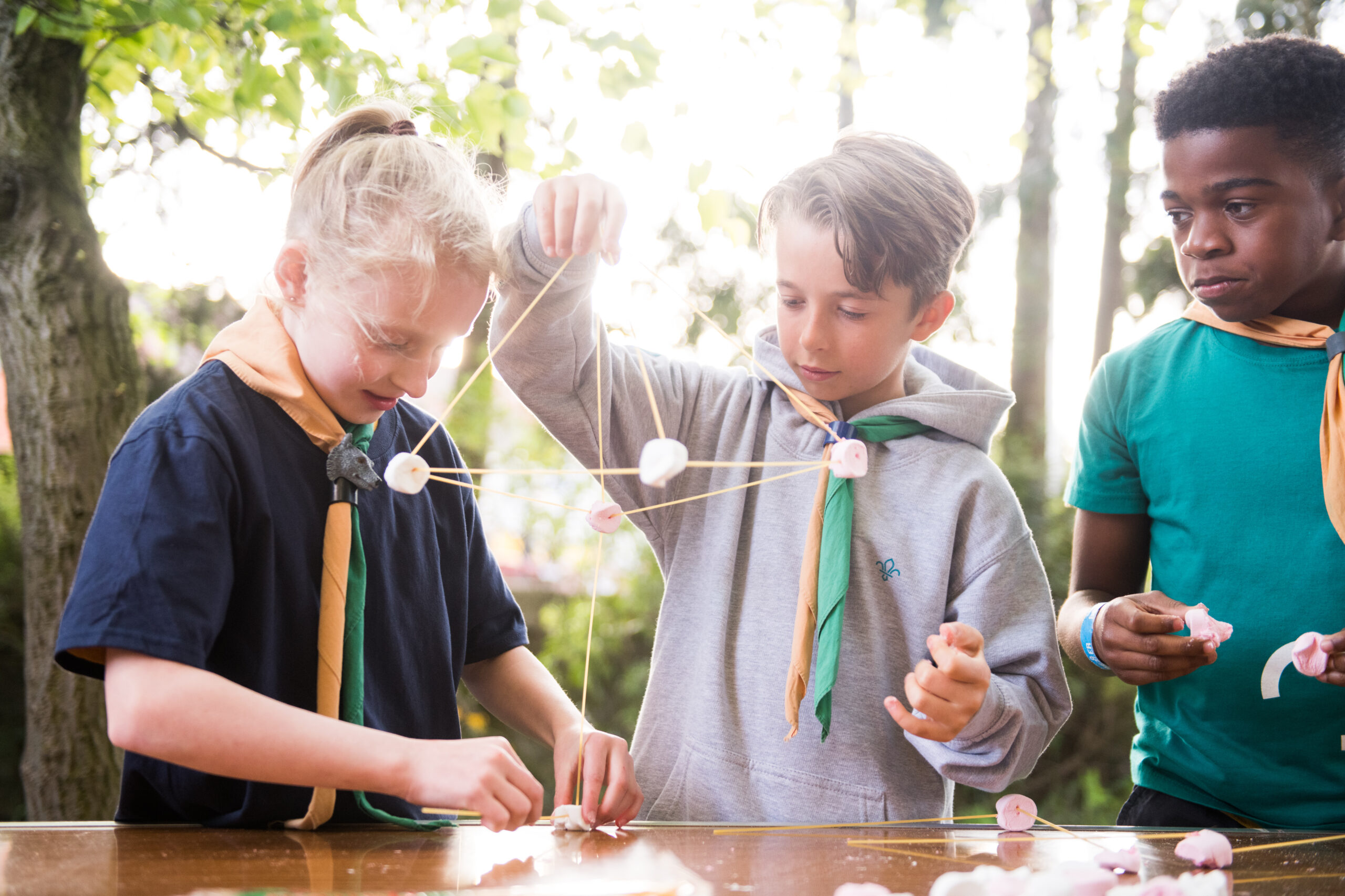 Three Cubs working together on a model-making activity